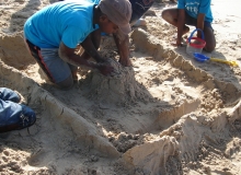 Team coming together to make huge sand castle